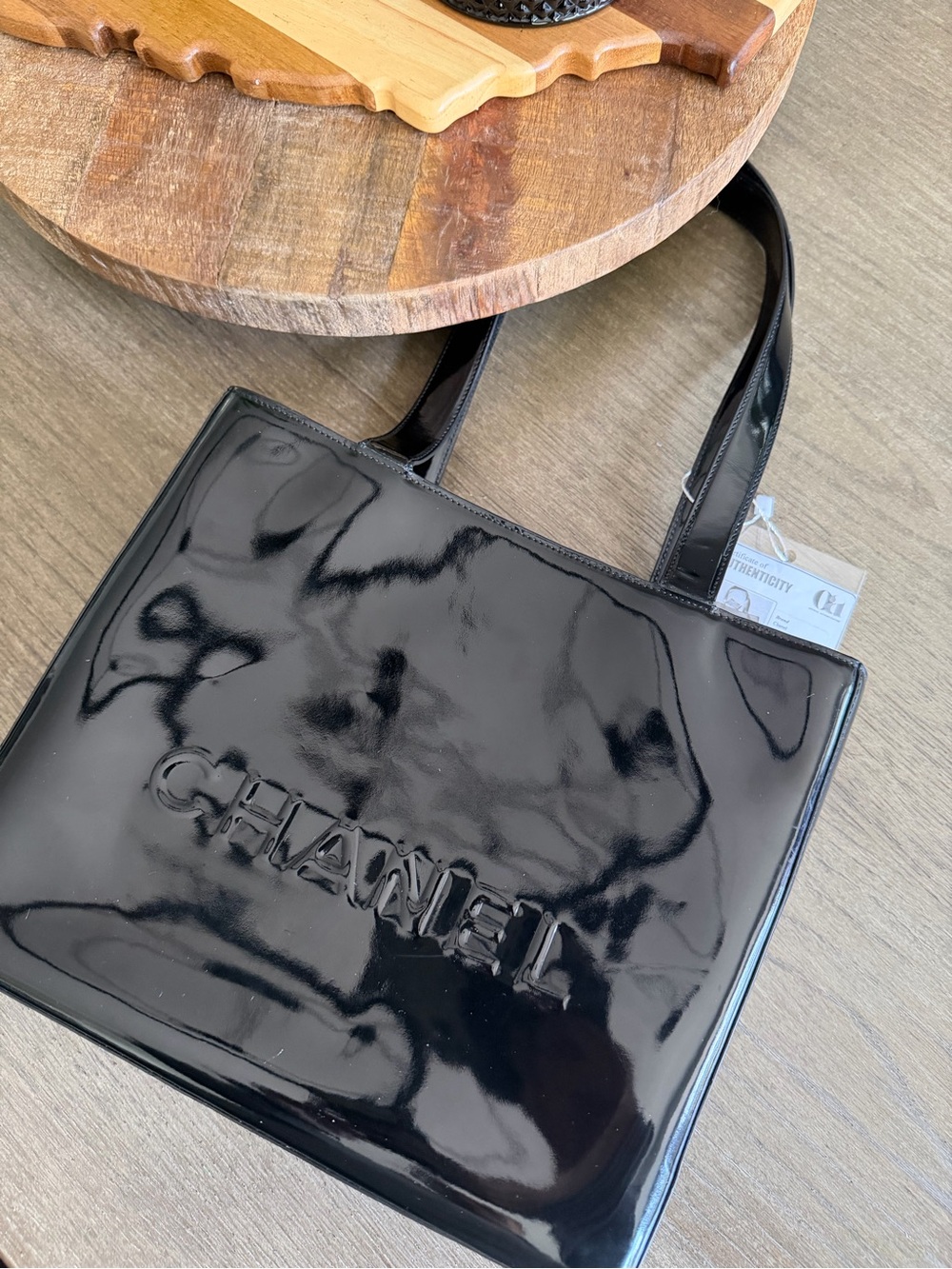 CHANEL Black Patent Leather Tote with Embossed Logo